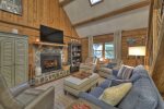 Screened-In Entertainment Area Features Wood burning Fireplace and Flat Screen Smart TV
